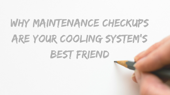 Hand holding a pencil writing "Why Maintenance Checkups Are Your Cooling System's Best Friend" on a blank page, emphasizing the importance of maintenance for cooling systems in HVAC context.